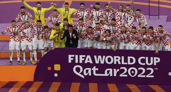 Croatia’s players celebrate with medals after winning the Qatar 2022 World Cup football third place play-off match between Croatia and Morocco